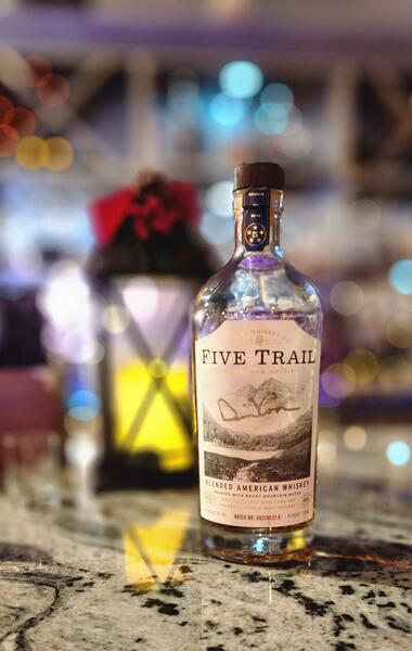 Five Trail blended American whiskey by Coors Whiskey Co. amid holiday bar lights