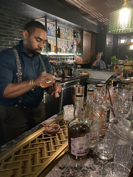 Bartender measuring a pour during a Gin Lane 1751 tasting