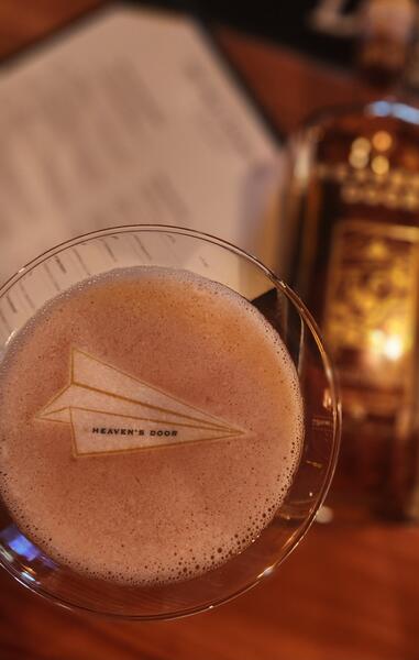 Heaven's Door paper-plane logo printed on cocktail foam